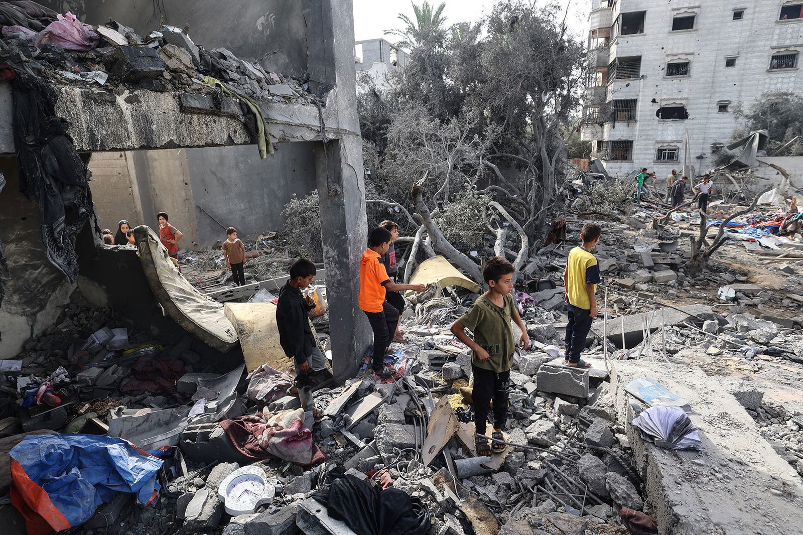 <i>Eyad Baba/AFP/Getty Images via CNN Newsource</i><br/>Palestinian children check the rubble of a residential house in Deir el-Balah in the central Gaza Strip on July 1