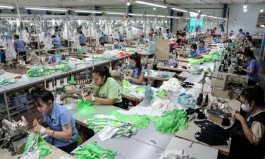 Vietnamese garment factory workers stitch apparel at a factory in Ho Chi Minh City.