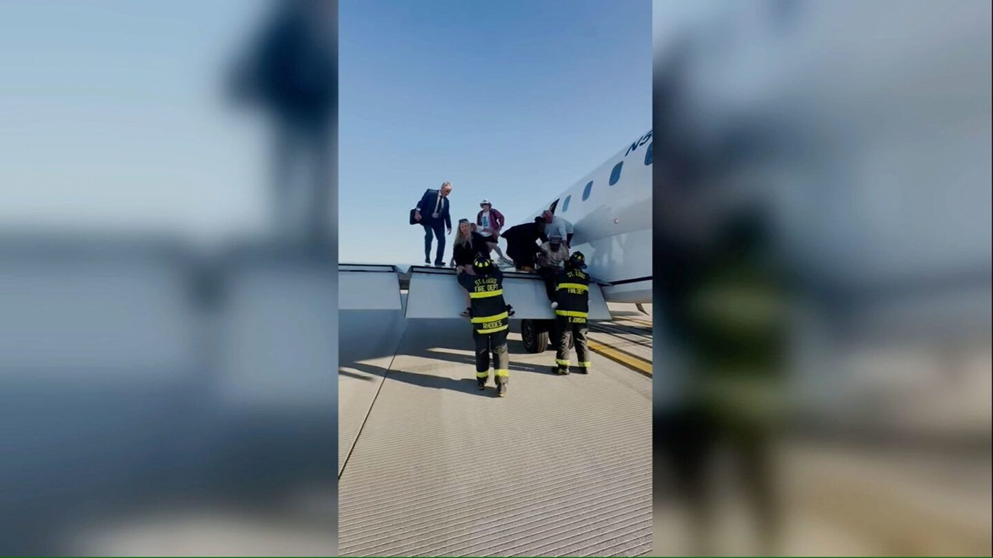 <i>Courtesy Dominic Gagliardotto via CNN Newsource</i><br/>Passengers climb off the the wing of United Express flight 4423 after it made an emergency landing in St. Louis.