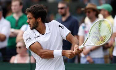 A black ribbon is worn by Francisco Cabral of Portugal as he plays his men's doubles second-round match on Friday at Wimbledon.