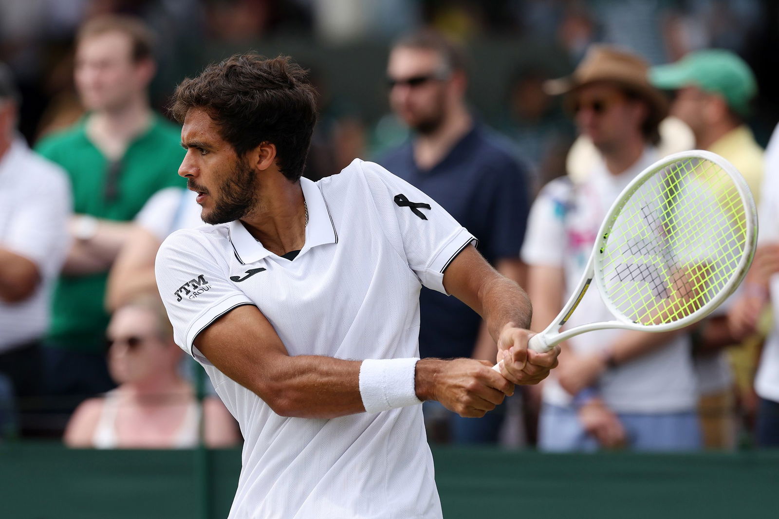 <i>Ezra Shaw/Getty Images via CNN Newsource</i><br/>A black ribbon is worn by Francisco Cabral of Portugal as he plays his men's doubles second-round match on Friday at Wimbledon.