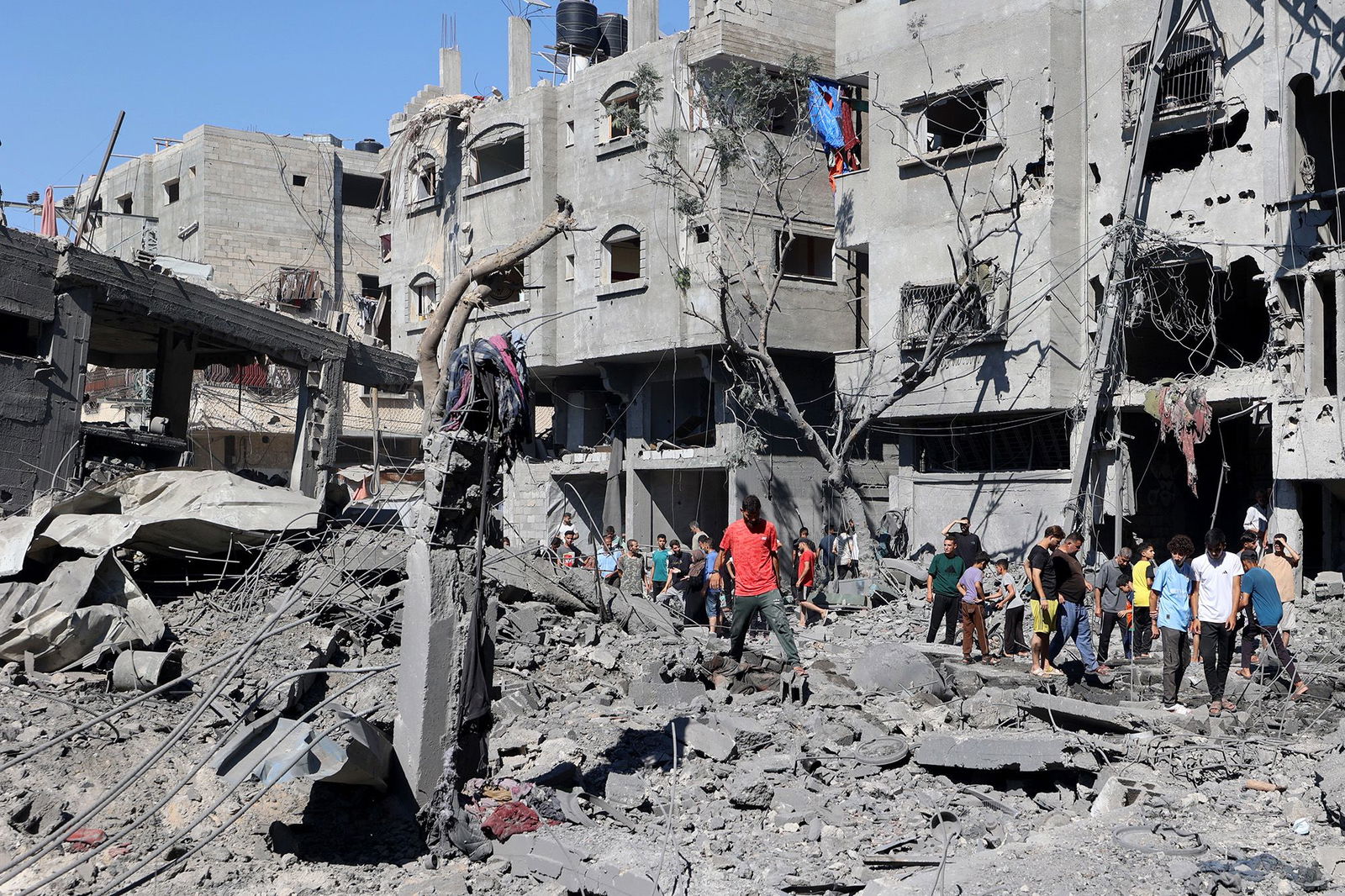 <i>Eyad Baba/AFP/Getty Images via CNN Newsource</i><br/>Palestinians inspect the damage after an Israeli strike in the Al-Bureij camp in central Gaza on July 4.