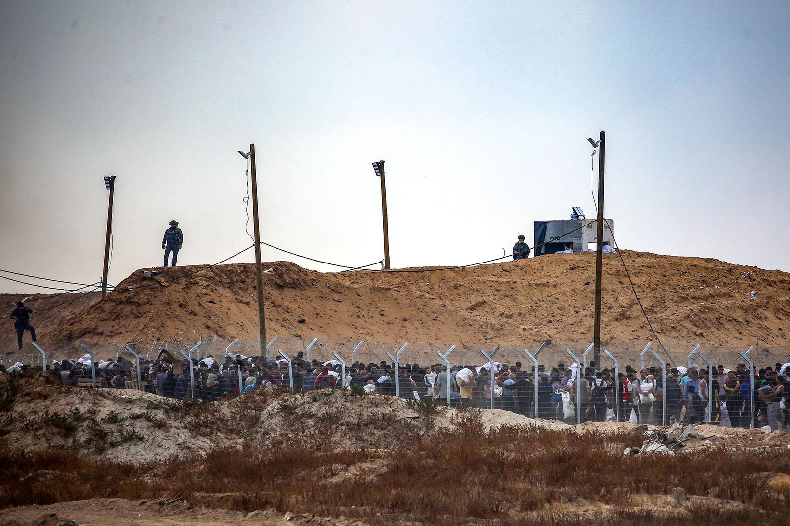<i>Hatem Khaled/Reuters via CNN Newsource</i><br/>People carry a body as they mourn Palestinians who were killed in an incident on July 16 while seeking aid in Khan Younis in the southern Gaza Strip on July 16.