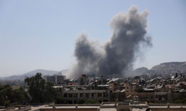 Smoke rises after strikes on Syria's defense ministry in Damascus on July 16.