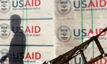 The shadow of a Philippine Army personnel is cast on boxes of relief items from U.S. Agency for International Development (USAID) for the victims of super typhoon Haiyan