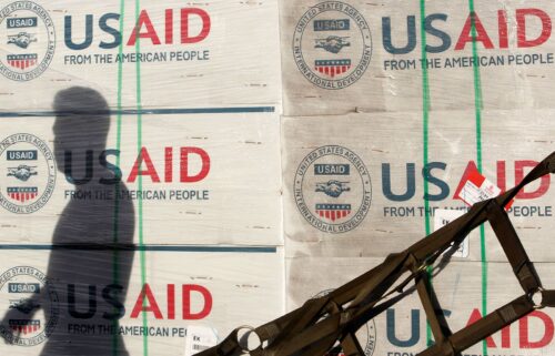 The shadow of a Philippine Army personnel is cast on boxes of relief items from U.S. Agency for International Development (USAID) for the victims of super typhoon Haiyan