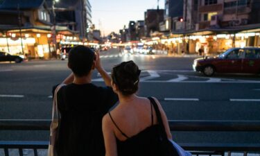 People cross the iconic Shibuya crossroads on June 17 in Tokyo