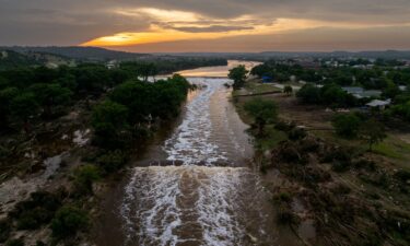 The sun sets over the swollen Guadalupe River in Kerrville