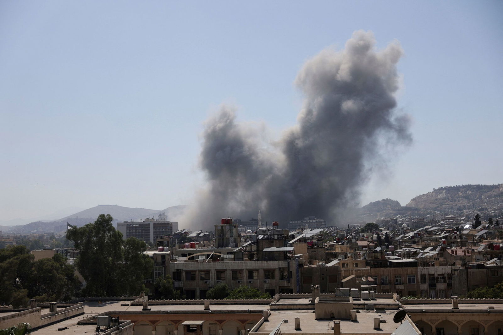 <i>Khalil Ashawi/Reuters via CNN Newsource</i><br/>Smoke rises after strikes on Syria's defense ministry in Damascus