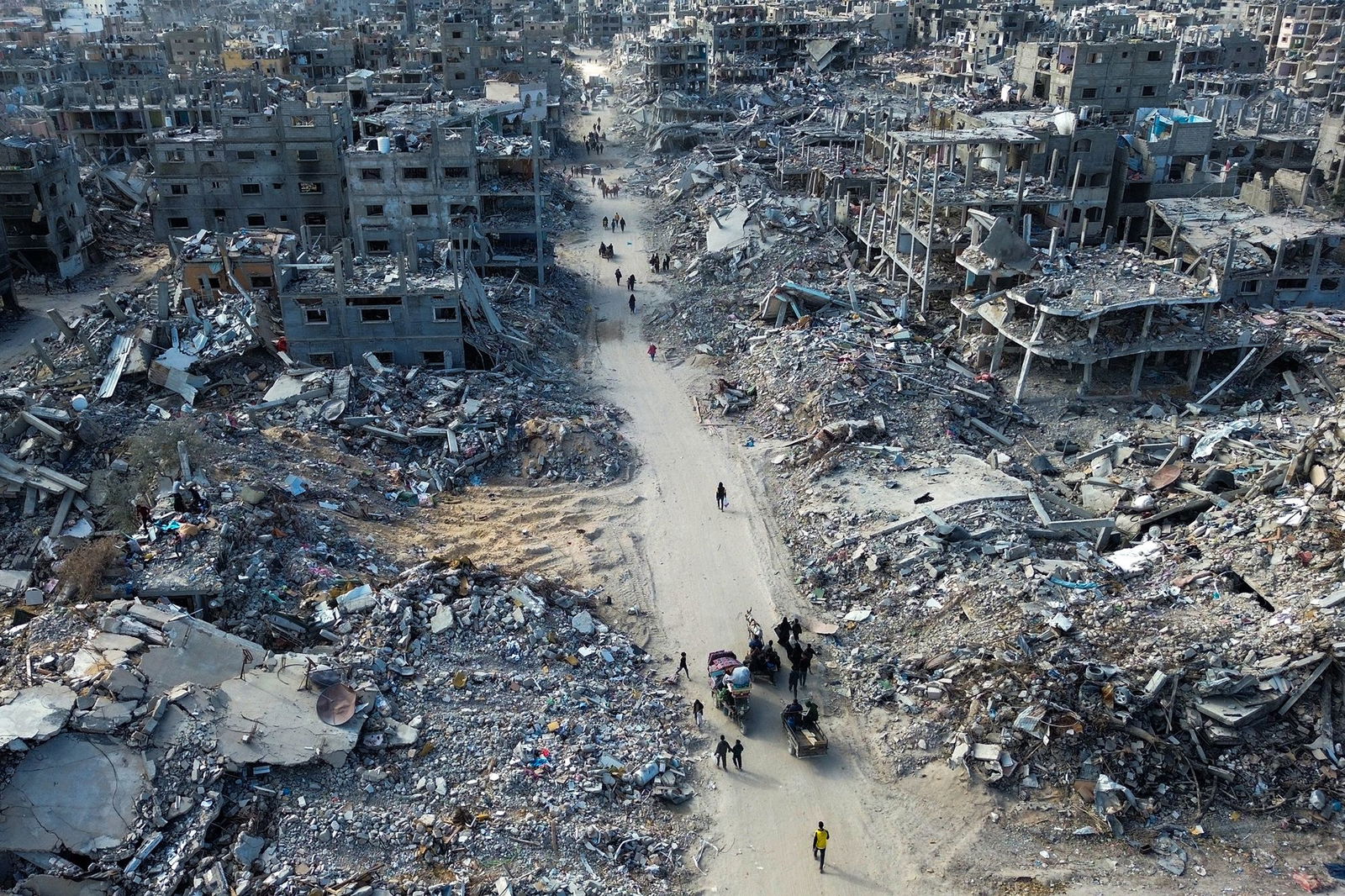 <i>AFP/Getty Images via CNN Newsource</i><br/>People make their way past the rubble of houses in Rafah