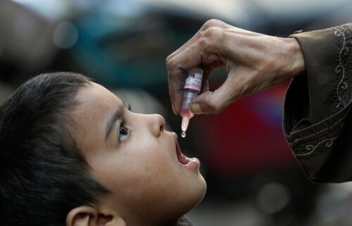 A health worker administers a polio vaccine to a child in Karachi