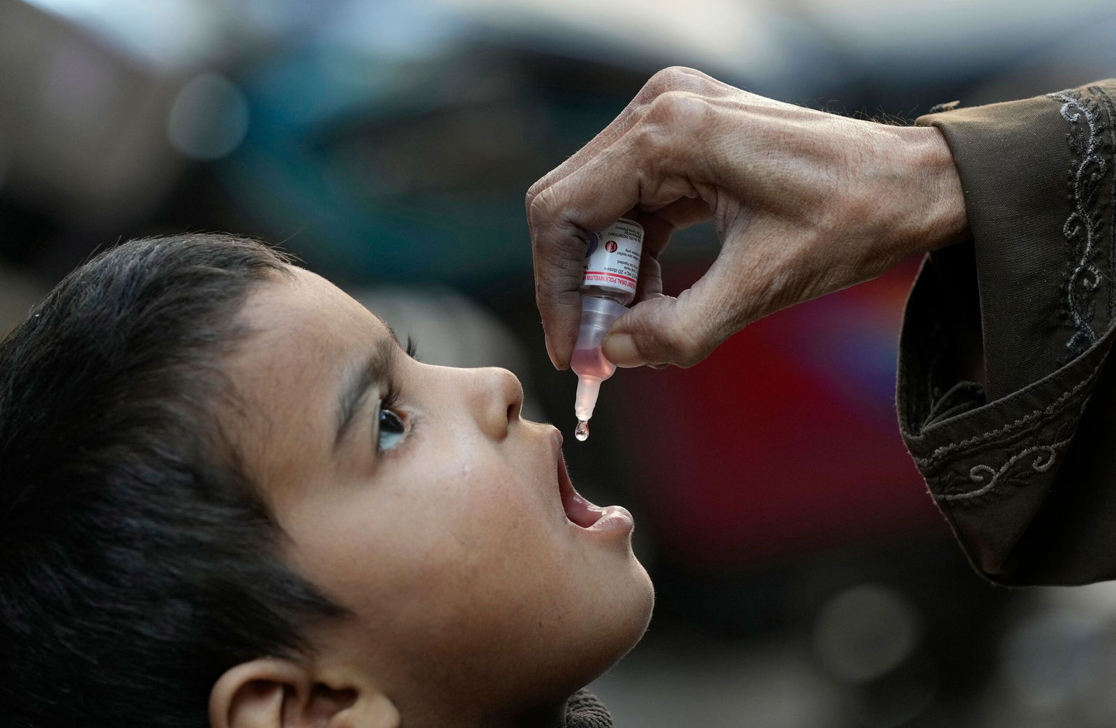 <i>Fareed Khan/AP via CNN Newsource</i><br/>A health worker administers a polio vaccine to a child in Karachi