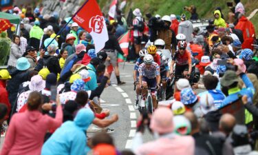 Spectators react as riders compete in the Tour de France's 14th stage.