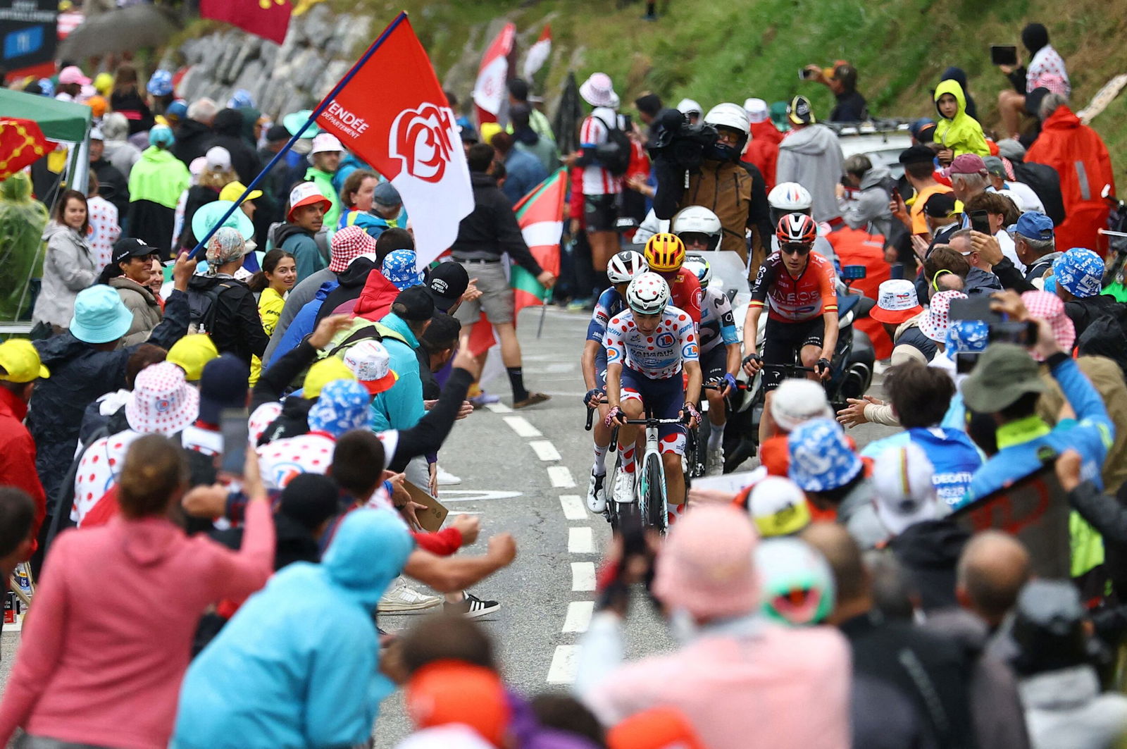 <i>Sarah Meyssonnier/Reuters via CNN Newsource</i><br/>Spectators react as riders compete in the Tour de France's 14th stage.