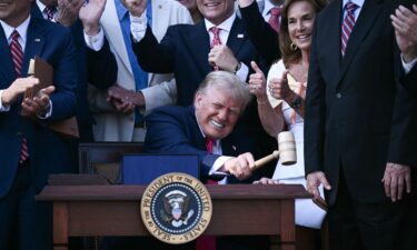 President Donald Trump bangs a gavel after signing a sweeping tax and spending cuts package he called his "big