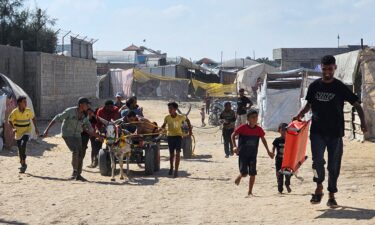 Palestinians in the southern Gaza Strip transport people who were injured while trying to get humanitarian aid on July 20.