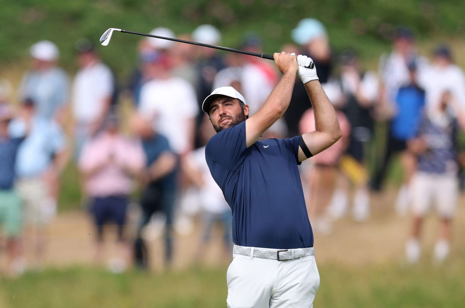 <i>Warren Little/Getty Images via CNN Newsource</i><br/>Scottie Scheffler hits his second shot on the 12th hole of The Open Championship on Sunday in Portrush