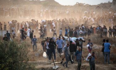 People carry relief supplies from the Gaza Humanitarian Foundation (GHF) on June 8