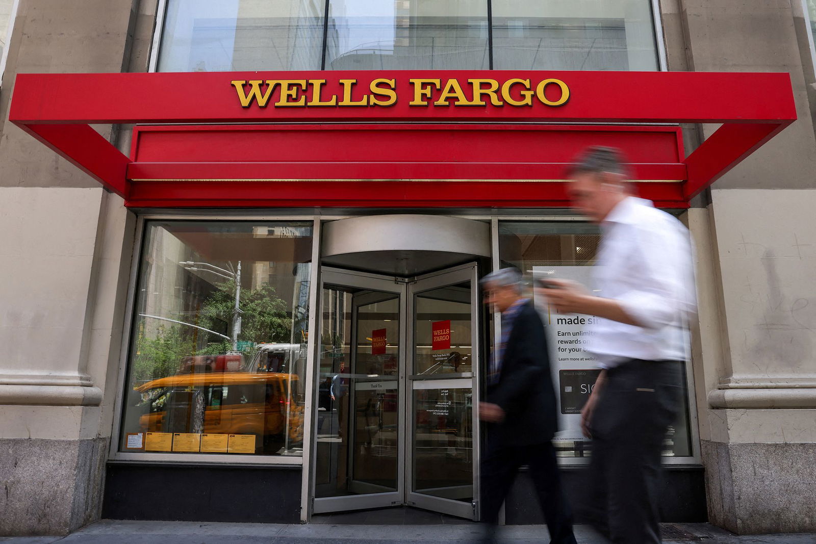 <i>Kylie Cooper/Reuters/FILE via CNN Newsource</i><br/>People walk by a Wells Fargo bank branch in New York City