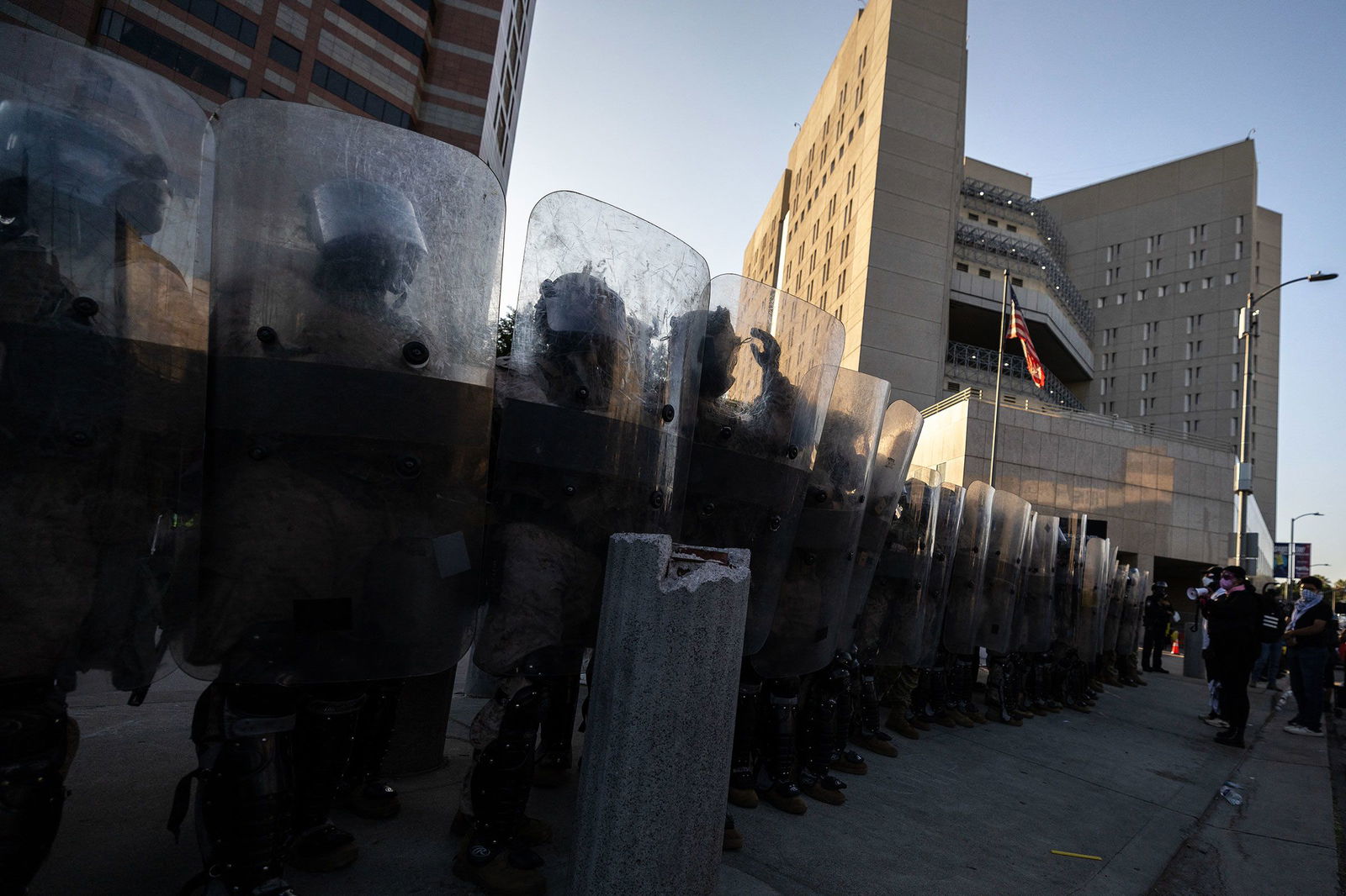 <i>Etienne Laurent/AFP/Getty Images via CNN Newsource</i><br/>US Marines and National Guard troops stand in line protecting the entrance of the Metropolitan Detention Center as demonstrators gather in front of it following federal immigration operations
