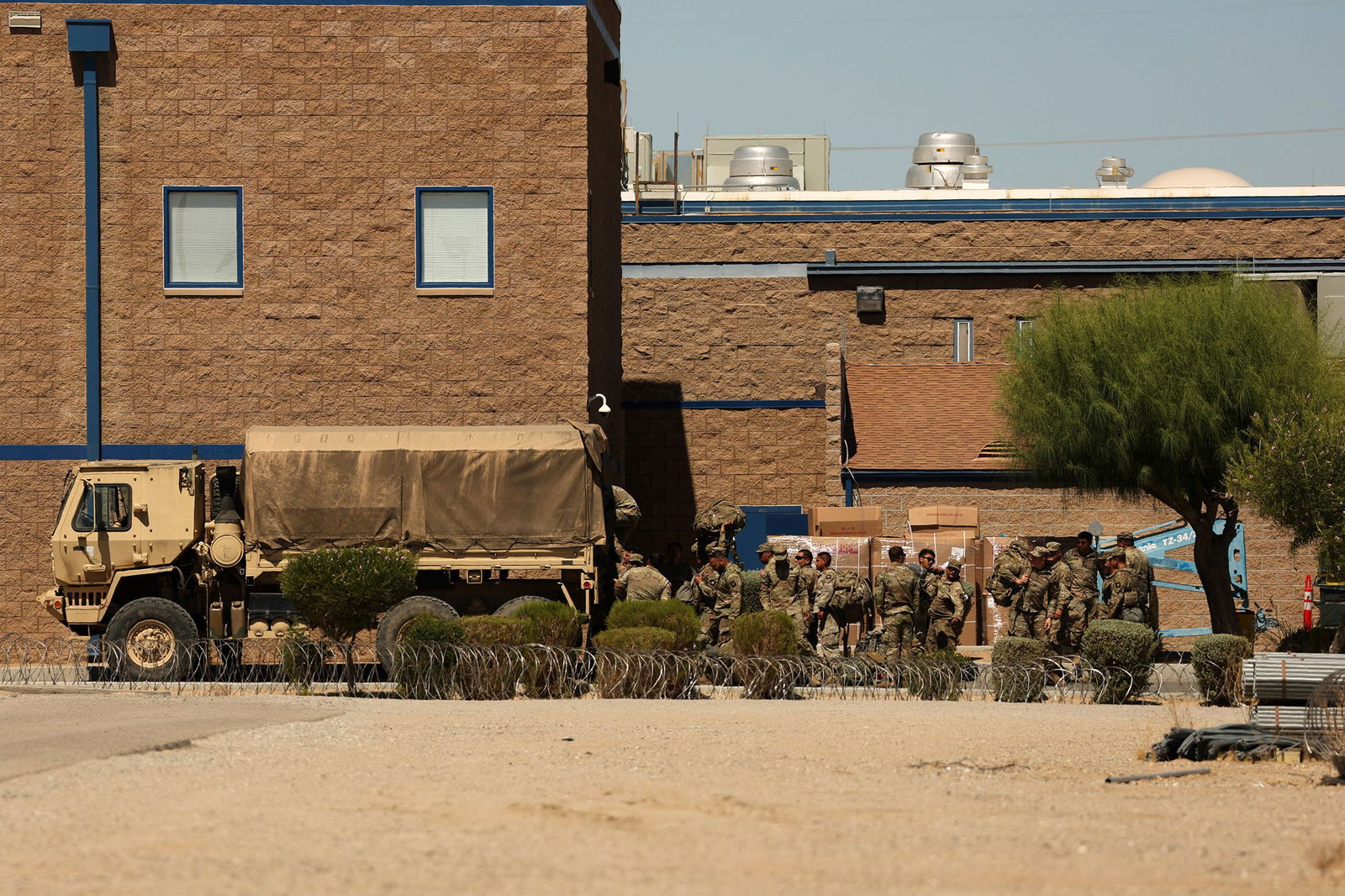 <i>Patrick T. Fallon/AFP/Getty Images via CNN Newsource</i><br/>Members of the California National Guard load a truck outside the private prison company GEO Group Adelanto ICE Processing Center detention facility in Adelanto