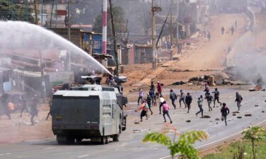 Riot police scatter protesters with water cannons during demonstrations to mark the historic 1990 Saba Saba protests for democratic reforms in the Kangemi slum of Nairobi