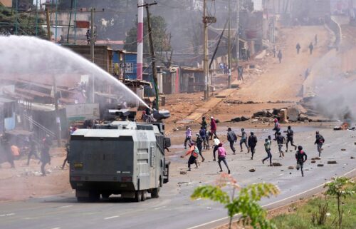 Riot police scatter protesters with water cannons during demonstrations to mark the historic 1990 Saba Saba protests for democratic reforms in the Kangemi slum of Nairobi
