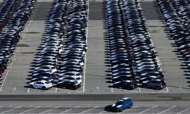 Brand new Subaru cars sit in a storage lot on March 24