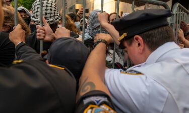Police push back protesters as they gather outside of Columbia University's Butler Library in New York