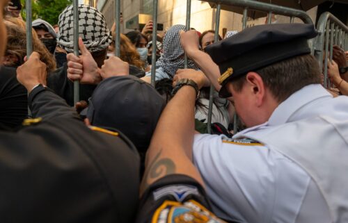 Police push back protesters as they gather outside of Columbia University's Butler Library in New York