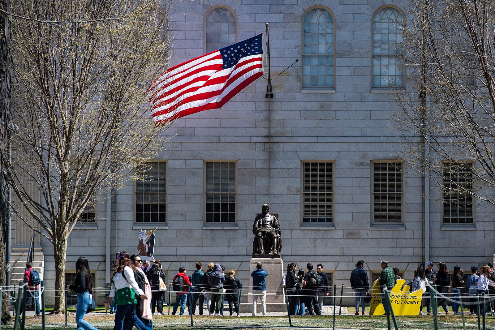 <i>Joseph Prezioso/AFP/Getty Images via CNN Newsource</i><br/>Demonstrators with signs stand around the John Harvard Statue in Harvard Yard after a rally was held against President Donald Trump's attacks on Harvard University at Harvard University in Cambridge
