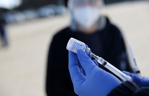 A healthcare worker prepares flu shots during a drive-thru clinic at the Louisiana State Fairgrounds in Shreveport