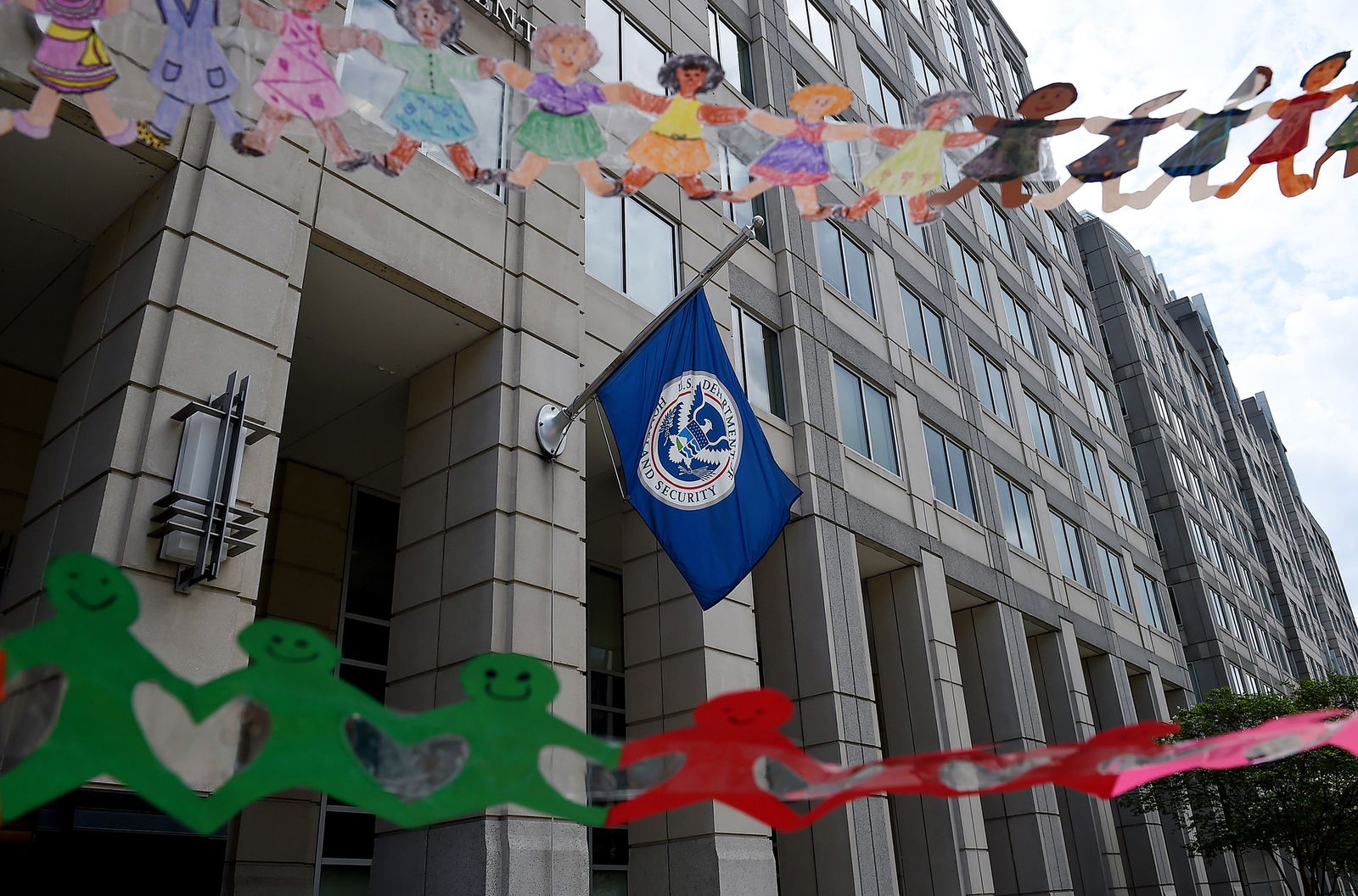 <i>Olivier Douliery/AFP/Getty Images via CNN Newsource</i><br/>Paper dolls are held by demonstrators protesting outside the Immigration and Customs Enforcement headquarters in July 2020. The Trump administration is moving to rapidly deport some migrant children who arrived in the US without a parent or guardian.