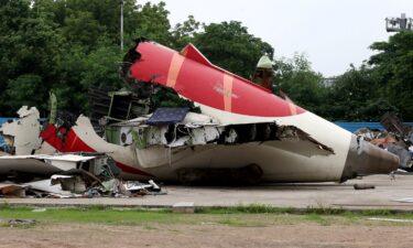 Wreckage of the Air India Boeing 787-8 Dreamliner plane sits on the open ground