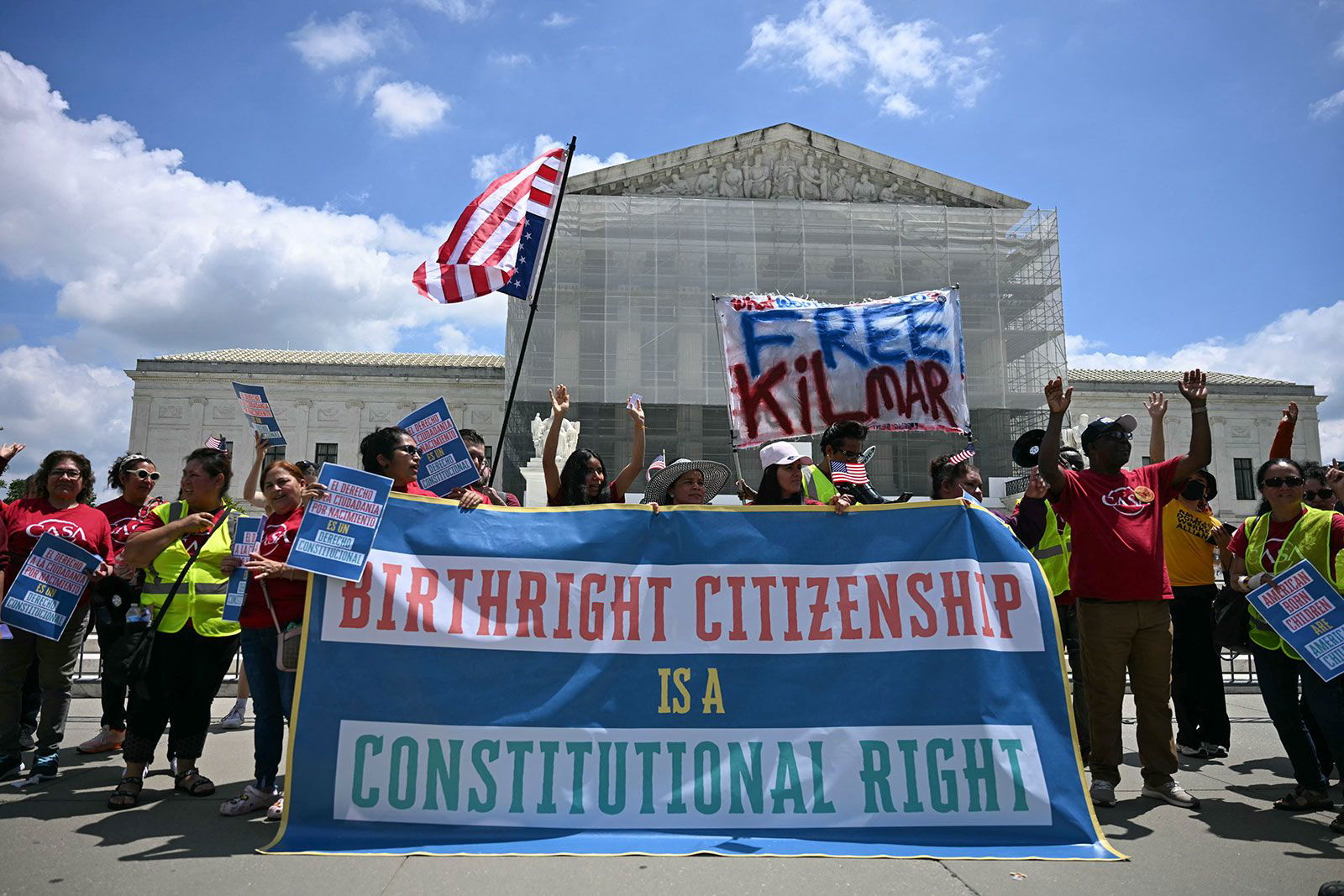 <i>Jim Watson/AFP/Getty Images/File via CNN Newsource</i><br/>People hold a banner as they participate in a protest outside the US Supreme Court over President Donald Trump's move to end birthright citizenship as the court hears arguments over the order in Washington