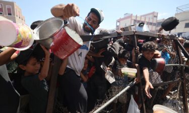 Palestinians gather at a food distribution point in the Nuseirat refugee camp in the central Gaza Strip on July 19. The World Food Programme said nearly one in three people in Gaza were not eating for days at a stretch and "thousands" were "on the verge of catastrophic hunger".
