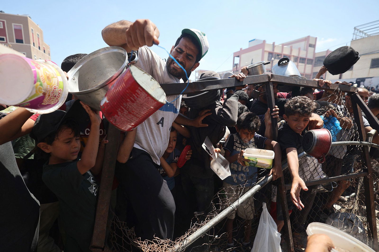 <i>Eyad Baba/AFP/Getty Images via CNN Newsource</i><br/>Palestinians gather at a food distribution point in the Nuseirat refugee camp in the central Gaza Strip on July 19. The World Food Programme said nearly one in three people in Gaza were not eating for days at a stretch and 