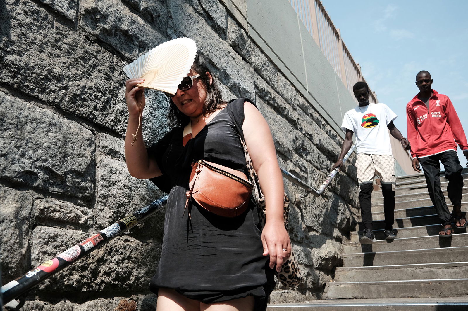 <i>Spencer Platt/Getty Images via CNN Newsource</i><br/>A woman shades herself from the sun as she tries to keep cool along the Brooklyn Bridge during a heat wave.