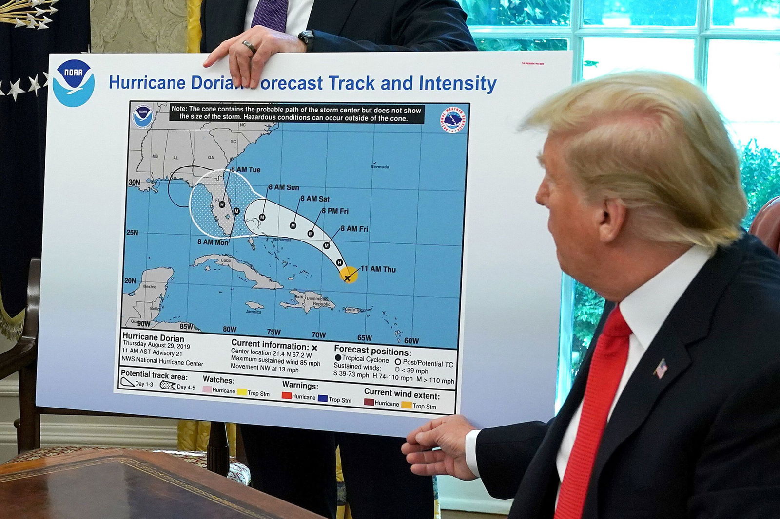 <i>Chip Somodevilla/Getty Images/FILE via CNN Newsource</i><br/>President Donald Trump references a map of a forecast for Hurricane Dorian in 2019. Trump drew on the map with a Sharpie to indicate the storm would track over Alabama. It did not.