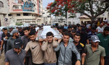 Palestinians gather to receive aid supplies in Beit Lahia