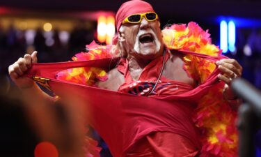 Hollywood Hulk Hogan puts a choke hold on the neck of Utah Jazz basketball star Karl Malone at a pay-per-view wrestling match Sunday July 12