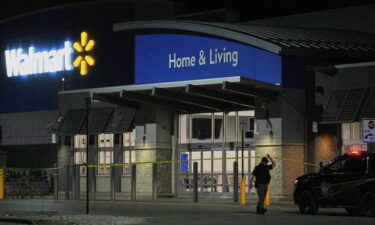 Police officers speak to Walmart employees outside a Walmart store