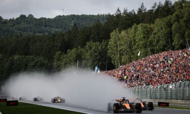 Race winner Oscar Piastri celebrates on the podium after winning the Belgian Grand Prix.