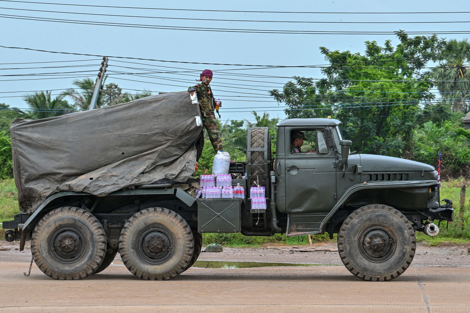 <i>Tang Chhin Sothy/AFP/Getty Images via CNN Newsource</i><br/>A Cambodian soldier stands on a truck carrying a Russian-made BM-21 rocket launcher travelling along a street in Oddar Meanchey province on July 26