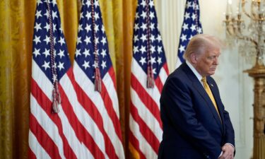 US President Donald Trump bows his head in prayer during a reception with Republican members of Congress in the East Room of the White House in Washington