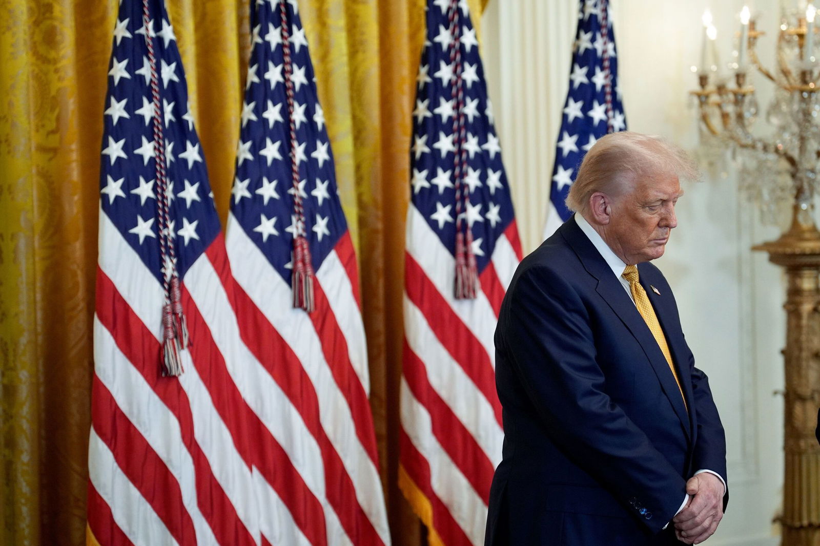 <i>Yuri Gripas/Abaca/Bloomberg/Getty Images via CNN Newsource</i><br/>US President Donald Trump bows his head in prayer during a reception with Republican members of Congress in the East Room of the White House in Washington