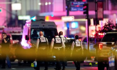 NYPD officers work near the scene of shooting in Manhattan Monday.