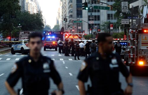 Police officers and emergency vehicles respond to a shooting in Midtown Manhattan on July 28.