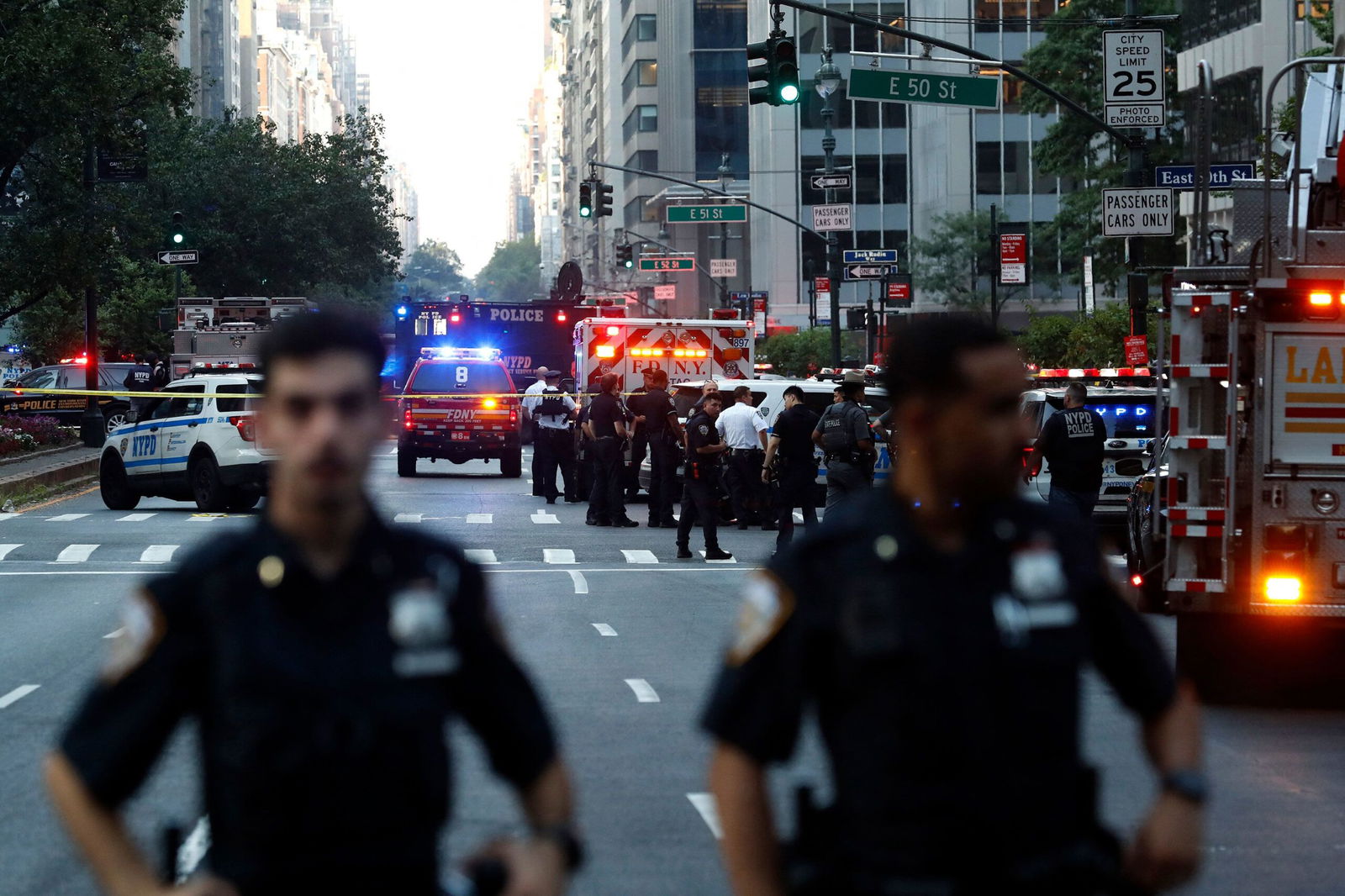<i>John Lamparski/AFP/Getty Images via CNN Newsource</i><br/>Police officers and emergency vehicles respond to a shooting in Midtown Manhattan on July 28.
