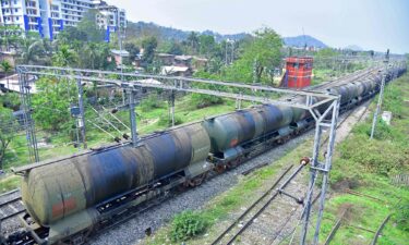 An oil tankers train passes near the Guwahati Refinery operated by Indian Oil Corporation.